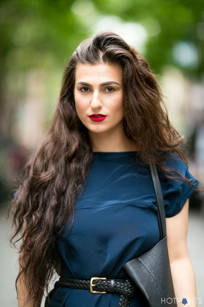 Sexy attractive beautiful brown-haired woman in a black stylish T-shirt in  stylish black leggings