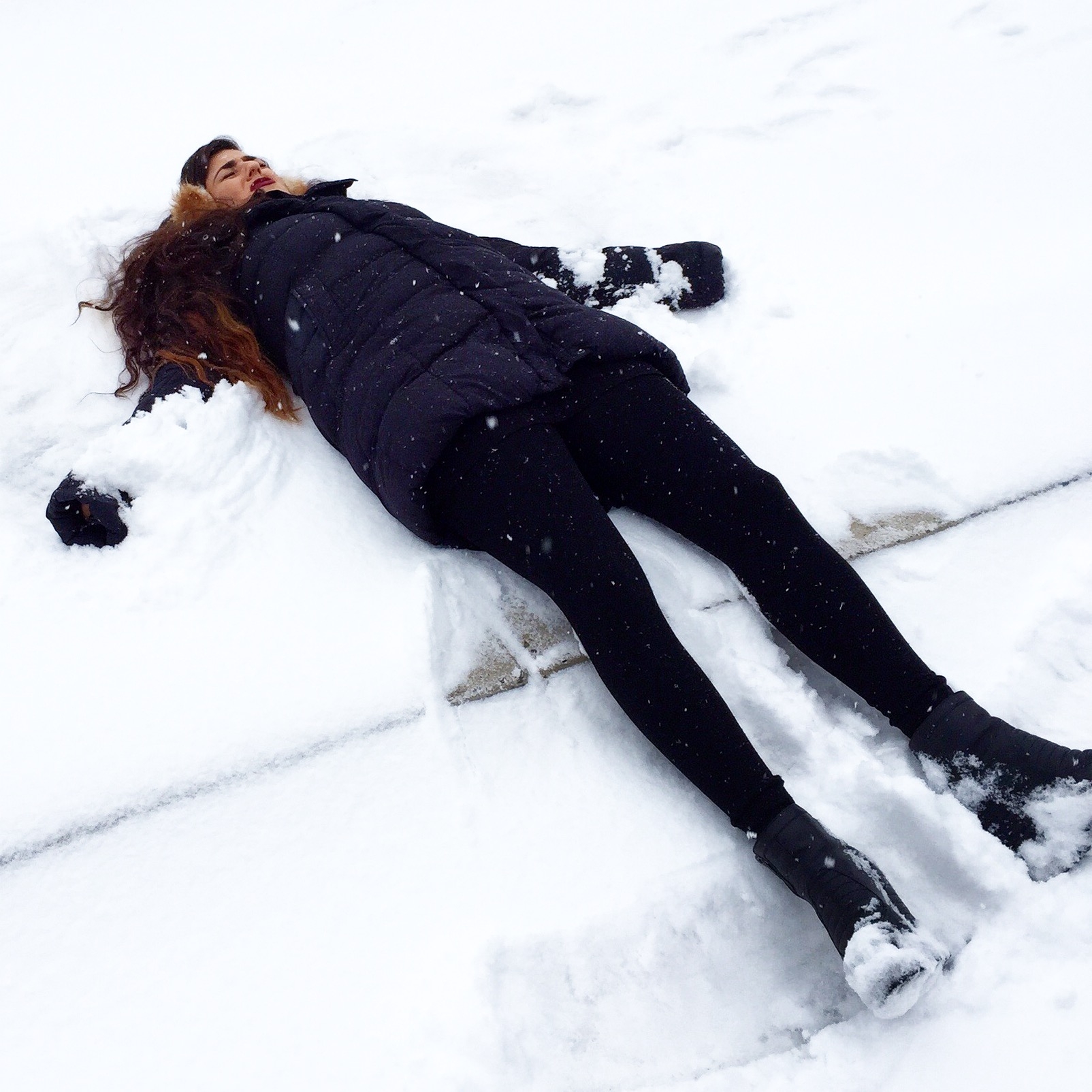 Funny Girl Playing in the Snow Making Snowmen