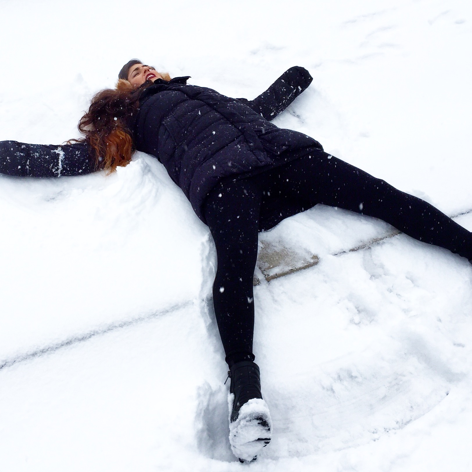 Funny Girl Playing in the Snow Making Snowmen