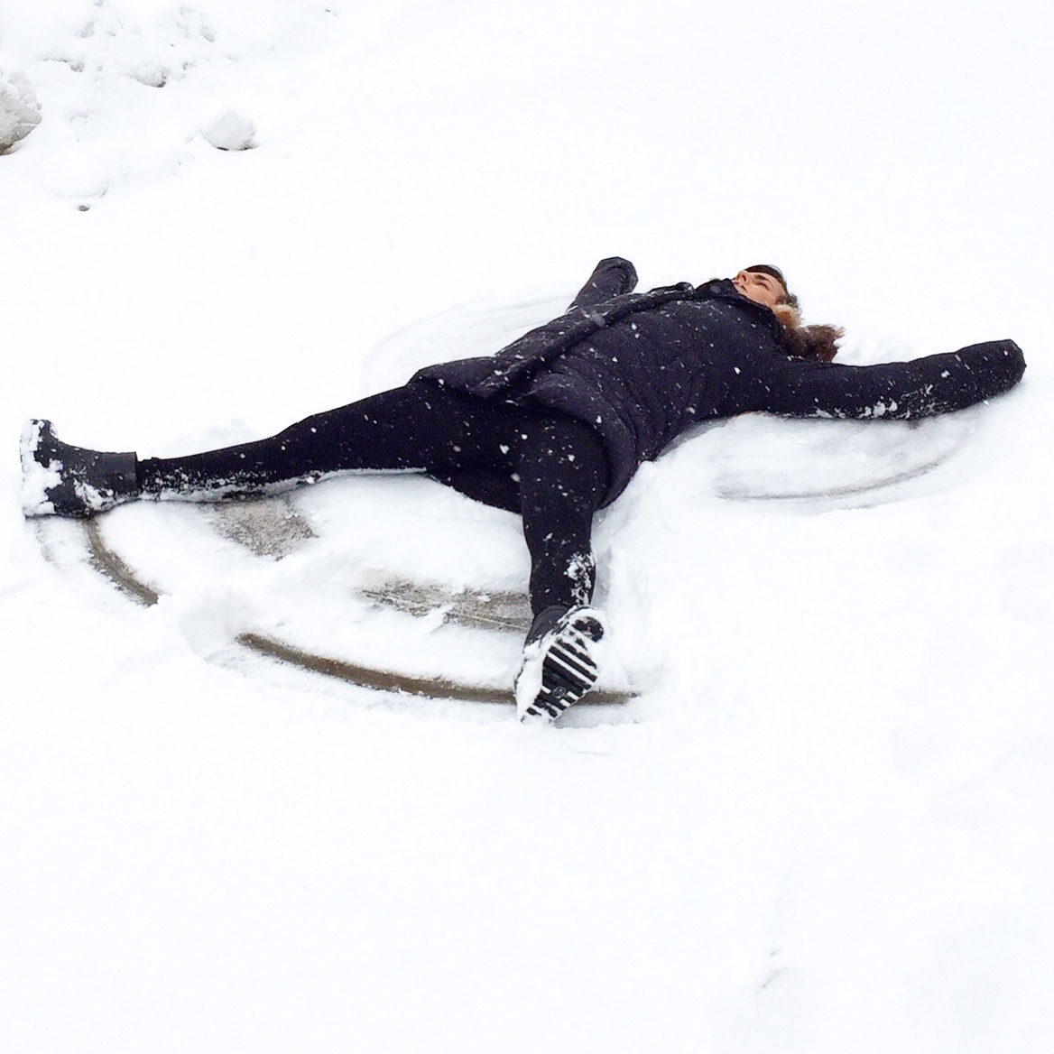 Funny Girl Playing in the Snow Making Snowmen