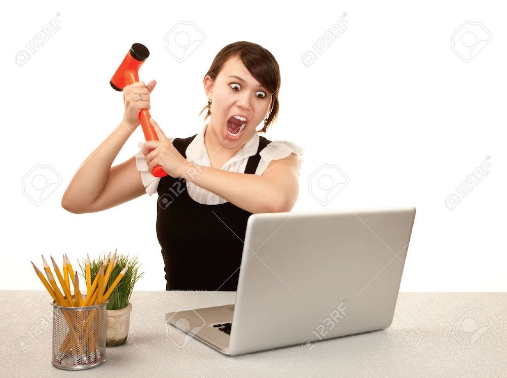 6570582-Pretty-female-office-worker-destroying-laptop-computer-Stock-Photo